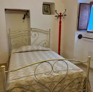 a bedroom with a white bed with a red ribbon at Trulli Cocolicchio in Selva di Fasano