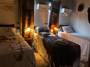 a room with two beds and two lamps in it at Recanto do sossego in Sinop