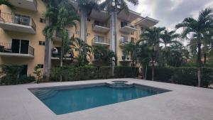 a swimming pool in front of a building at Condo Niko - Centrally Located, Steps to Beach! in Tamarindo