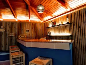 a bar in a room with wooden walls at Paralia Apts Stavros in Milatos