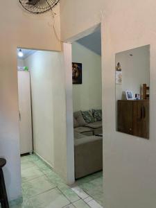 a hallway to a living room with a couch at Casa de férias em trindade paraty in Paraty