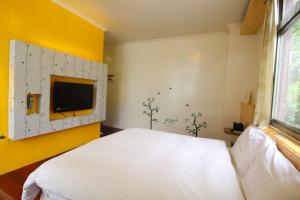 Letto o letti in una camera di Cocos Hot Spring Hotel