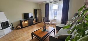 a living room with a couch and a coffee table at House of the Sun in Ventspils