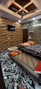 a room with two beds on the floor at Aggarwal independent apartments fully ac with private kitchen for self cooking having all utensils and Fridge and washroom along with all facilities of your sweet home, high speed wifi, fridge , smart tv , work desk in New Delhi