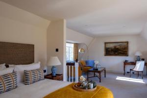a bedroom with a bed and a living room at Horsted Place Hotel in Uckfield