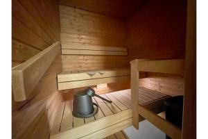 an inside view of a sauna with a trash can at Kotikaksio Chevron in Lahti