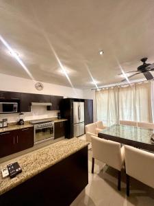 a kitchen with a table and chairs in a room at Condo Eden in Playa del Carmen