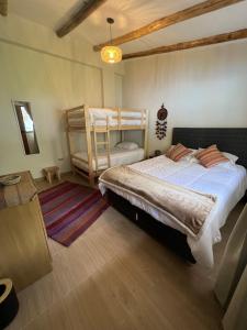 a bedroom with two beds and a bunk bed at Q'inti Apartment in Lamay