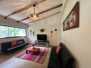 a living room with a couch and a table at Q'inti Apartment in Lamay