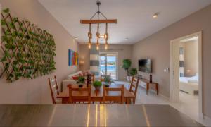 a dining room and living room with a dining table at Staylish Villas in Joubal Lagoon El Gouna in Hurghada