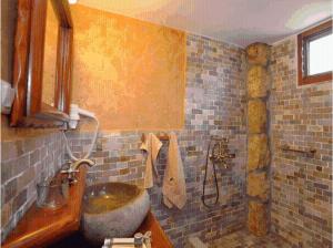 a bathroom with a sink and a shower at Apolithomeno Dasos Holiday Villas in Lefkimmi