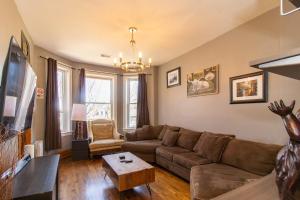 a living room with a couch and a table at Chi-Town Hideout #2 in Berwyn