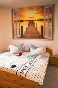 a bed with a painting of a pier at Kleine Mariken in Zingst