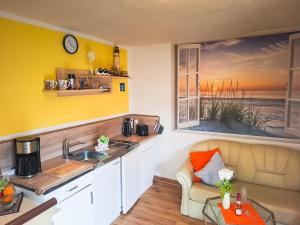 a kitchen with a sink and a window at Kleine Mariken in Zingst +26 photos