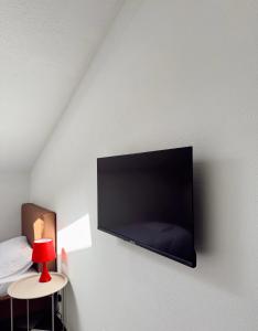 a flat screen tv hanging on a wall at Nook 95 Rooms in Prizren