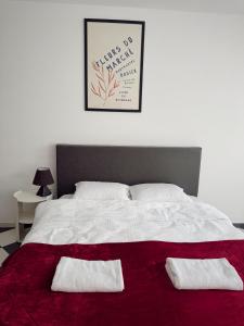 a bedroom with a bed with two pillows on it at Nook 95 Rooms in Prizren +8 photos