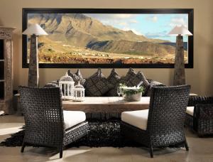 a living room with a painting of a mountain at Royal Garden Villas, Luxury Hotel in Adeje