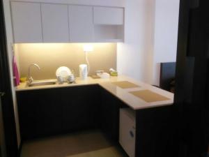 a small kitchen with a sink and a lamp at Studio Apartment Kota Bharu (KBCP) in Kota Bharu