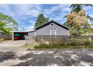 a house with a fence in front of it at Charming 2 bedroom house 1 mile from U of O in Eugene