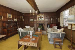 a living room filled with furniture and a fireplace at Haughley House in Stowmarket