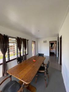 a dining room with a wooden table and chairs at Stephanie's Homestay in Matei +2 photos