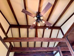 a ceiling fan hanging from the ceiling of a room at IZU Elysian View in Koura