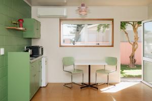 a kitchen with a table and two chairs at The Mayfair in Hastings