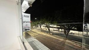 a hotel sign on the side of a building with a street at Hotel Monick in Teixeira de Freitas