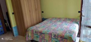 a bedroom with a bed with a quilt on it at Apartments in Eraclea Mare 53760 in Eraclea Mare
