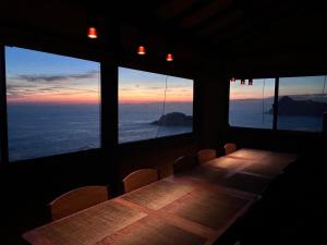 a table in a room with a view of the ocean at IZU Elysian View in Koura