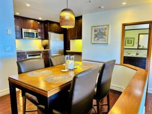a dining room with a wooden table and chairs at Ocean View Retreat W Pool Access in Avalon +9 photos