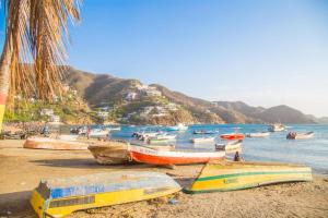 a group of boats on a beach near the water at Hospedaje Casa Taganga in Santa Marta