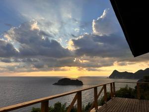 a view of the ocean from a balcony at IZU Elysian View in Koura
