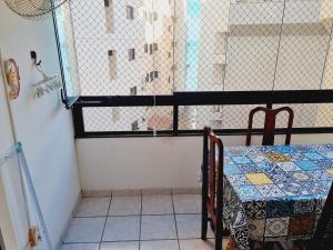 a small room with a table and a window at Ed Ravena Com vista mar e elevador in Guarapari