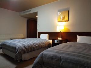 Postel nebo postele na pokoji v ubytování Route Inn Grantia Akita Spa Resort + 16 fotografií