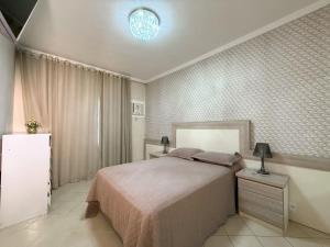 a bedroom with a bed and a light on the ceiling at House Condominium Pier 51 in Saí +21 photos