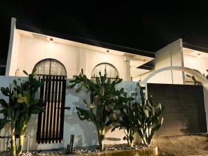 a white house with two trees in front of it at Cactus villa in General Santos