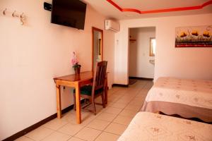 Postel nebo postele na pokoji v ubytování Hotel Doña Crucita