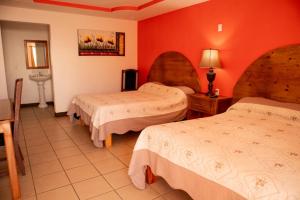 Postel nebo postele na pokoji v ubytování Hotel Doña Crucita