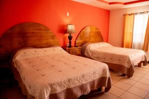 Postel nebo postele na pokoji v ubytování Hotel Doña Crucita