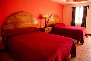 Postel nebo postele na pokoji v ubytování Hotel Doña Crucita