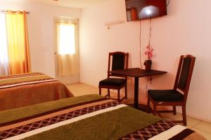 Postel nebo postele na pokoji v ubytování Hotel Doña Crucita