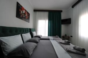 a bedroom with two beds with pillows on it at Vila Eni - Mario in Ksamil