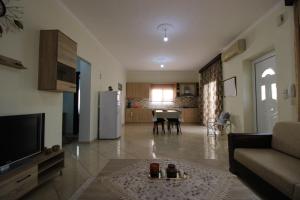 a living room with a couch and a table at Vila Eni - Mario in Ksamil