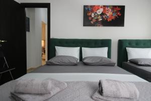 a bedroom with a large bed with two pillows at Vila Eni - Mario in Ksamil