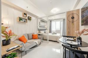 a living room with a couch and a table at Kajas Condo Luxe at Primeworld District near Mactan-Cebu International Airport in Lapu Lapu City
