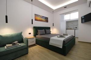 a bedroom with a bed and a couch at Vila Eni - Mario in Ksamil
