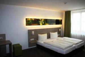 Voodi või voodid majutusasutuse Schwarzer Adler - Hotel Garni toas
