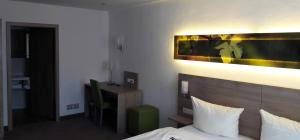 Voodi või voodid majutusasutuse Schwarzer Adler - Hotel Garni toas