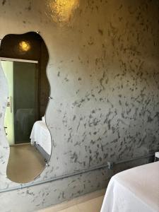 a mirror on a wall in a room at Pousada Água Salgada in Ilha de Boipeba